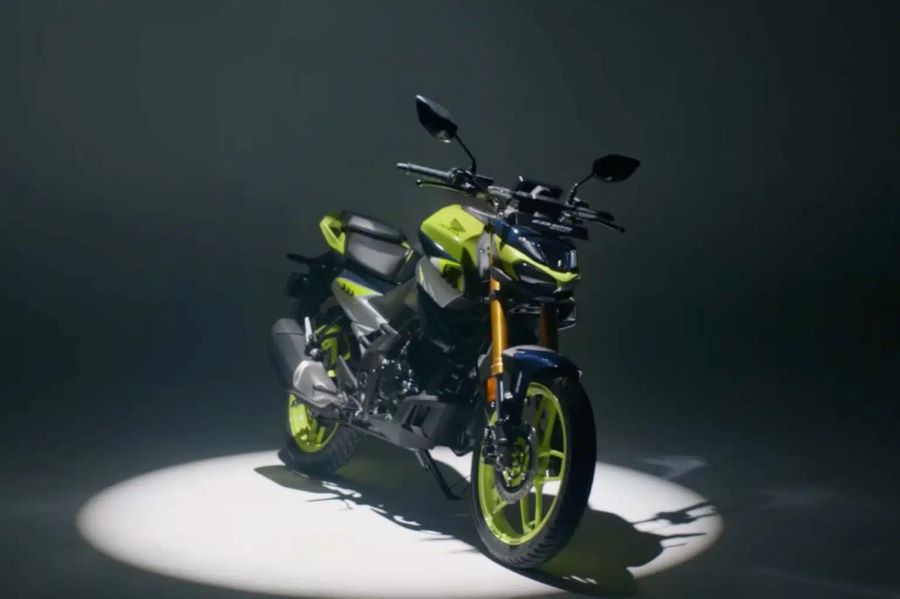 Una Honda CB125 Hornet amarilla flúor debajo de un halo de luz