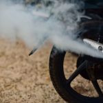 Una escape de moto larga humo blanco