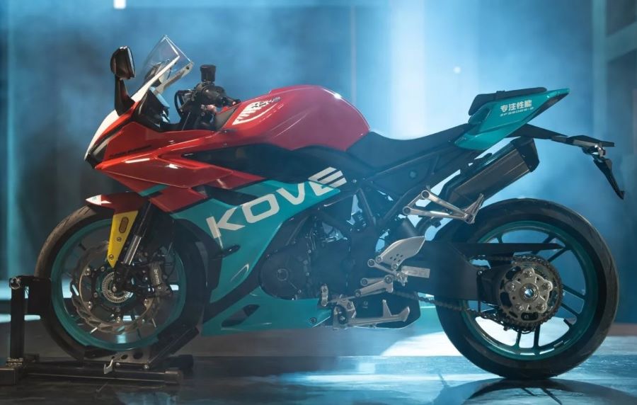 Una moto Kove 350RR parada en medio de efectos de humo y luces