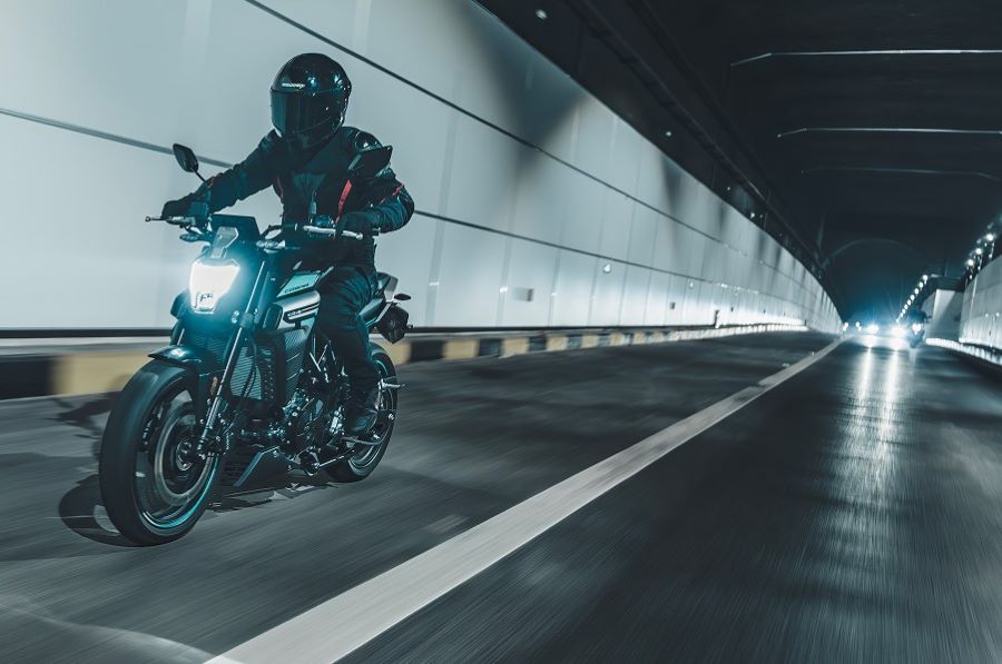 Una moto Kove 350R avanza por el interior de un túnel carretero