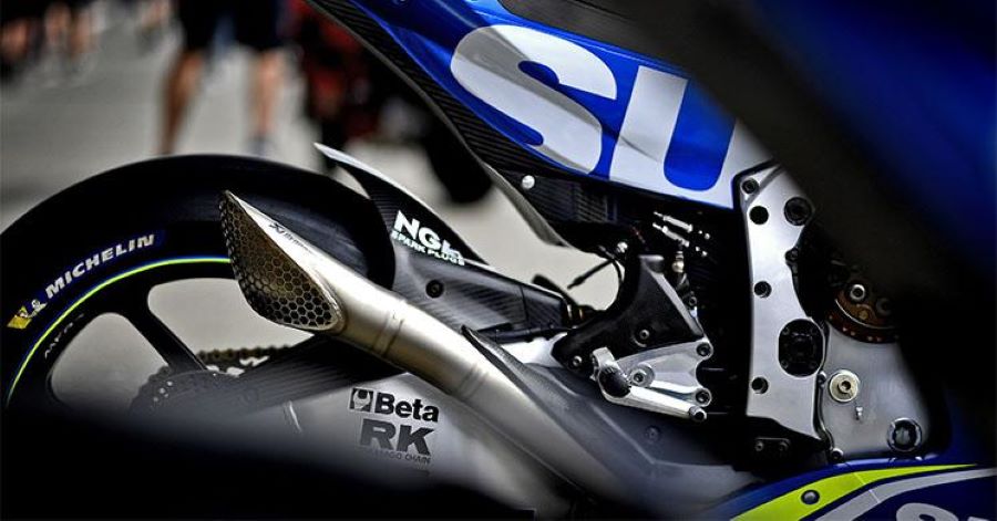 Una moto Suzuki conta un contorneado escape deportivo Akrapovic