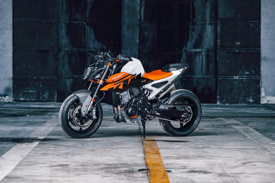 Una moto KTM 990 Duke 2026 naranja y blanca dispuesta para una foro de estudio