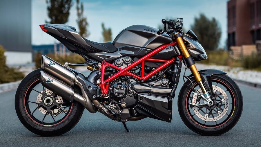Una moto ducati negra deja ver su chasis multitubular rojo