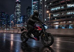 Una moto eléctrica Oben Rorr EVO se desplaza en la ciudad por la noche