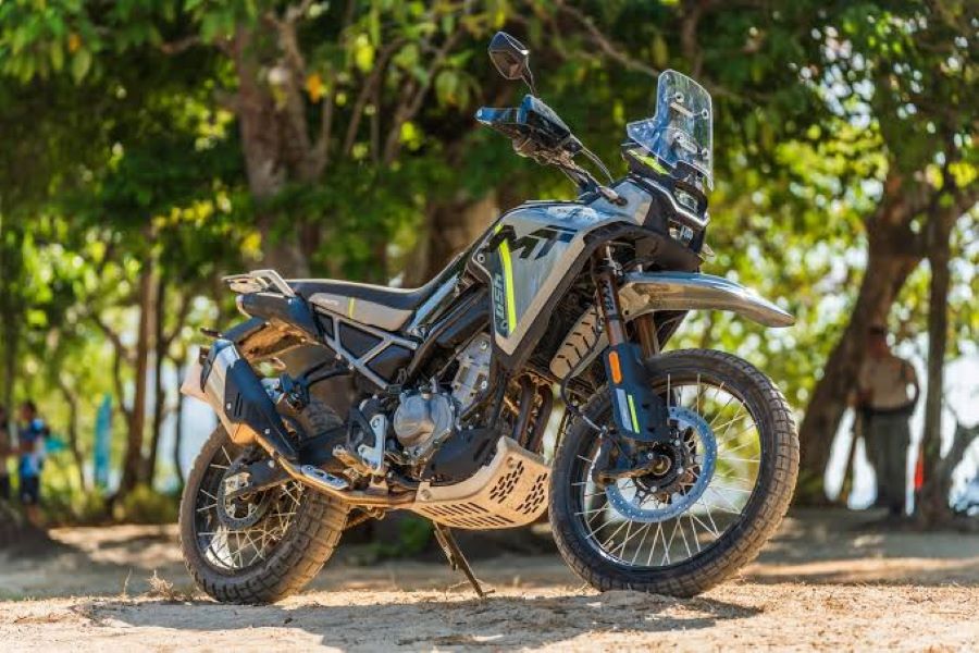 Una CFMoto 450MT descansa en medio de un bosque